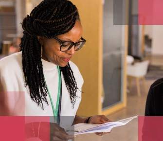 Female African American teacher looking at papers in a school setting